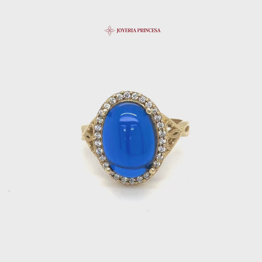 Anillo de oro de 14 quilates con cabujón azul y halo de circonitas